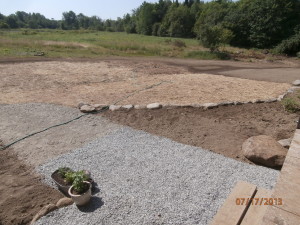 gravel walk-way, newly-seeded lawn and garden beds. 