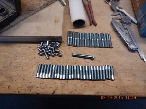 Turning 3/8" steel bolts into custom cabinet hinges.  Step 1: cut bolts to length.