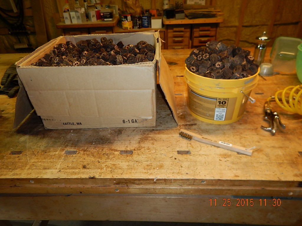 A big box of dirty butternut beads and a bucket of clean ones.