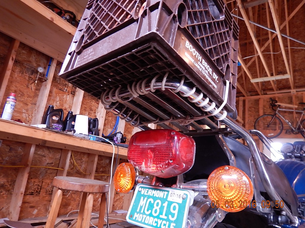 Store-bought luggage racks are expensive.  The milk crate might just be as old as the motorcycle. 