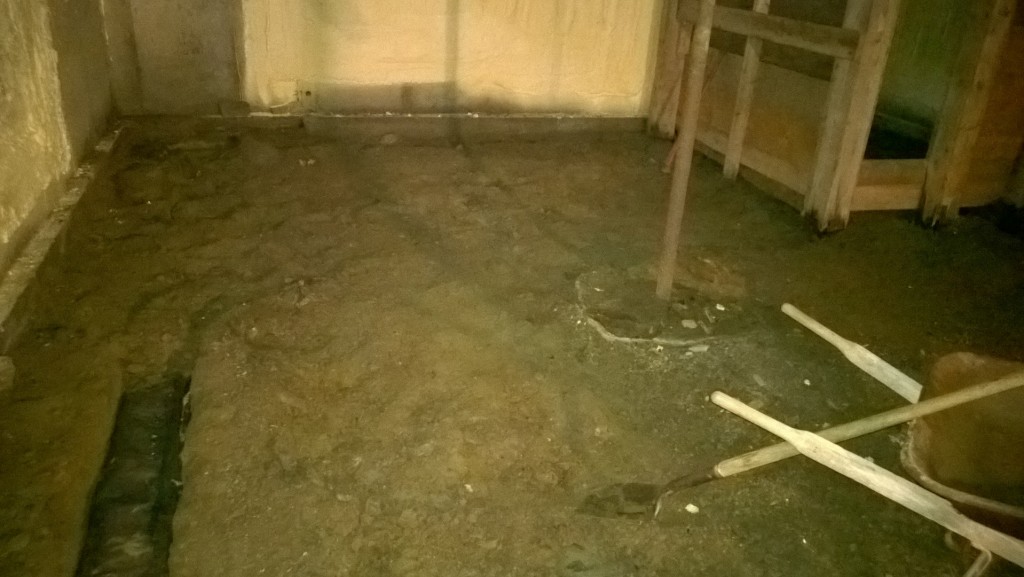 Like a lot of things next door, the basement is fundamentally flawed: the floor is already lower than the footings, so the buried drainage pipes had really better work.