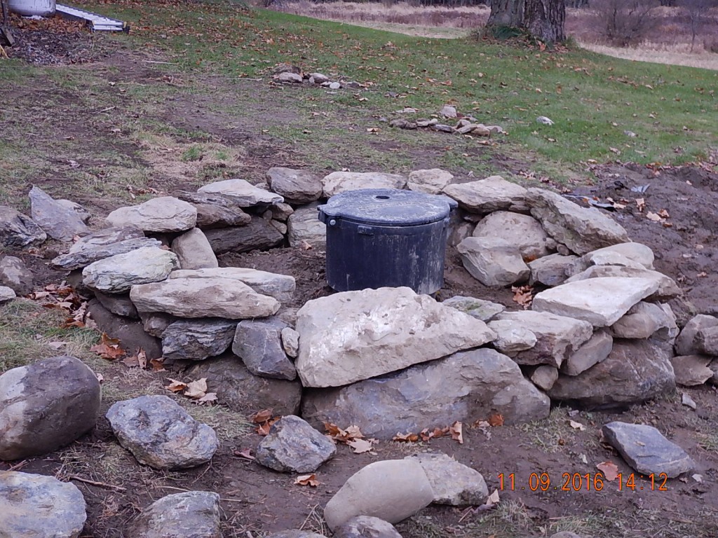When I had to disguise our septic system's manholes, I built the ellipse and a garden around them.  For the new propane tank next door, I made a stone circle and called it a garden. "Keep it simple" is my motto. 
