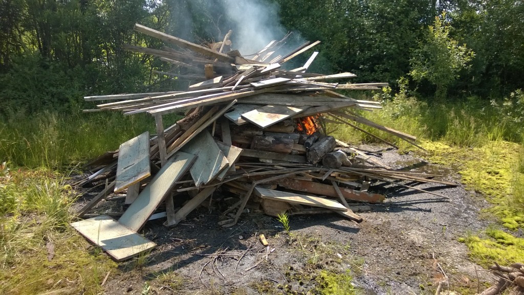 Even with all the wet weather we've had, an 8' tall pile of scrap wood still burns.  (with the help of a liberal sprinkling of diesel fuel)