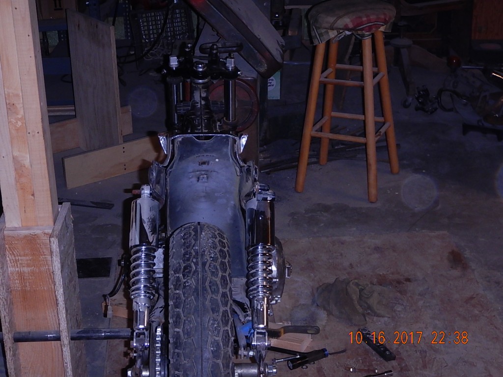 This photo is looking directly down the centerline of the frame. The engine drive sprocket aligns exactly with the driven wheel sprocket, and the rear frame's center holes align exactly with the weld seam of the front frame.  And yet the wheel is visibly 1/2" left of the frame's center. Drives me nuts.  