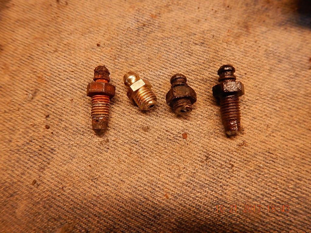 Four bleeder valves: A rusted out mess. The wrong size. A sheared off half. A good one. Honda discontinued this part number, but ... no problem!