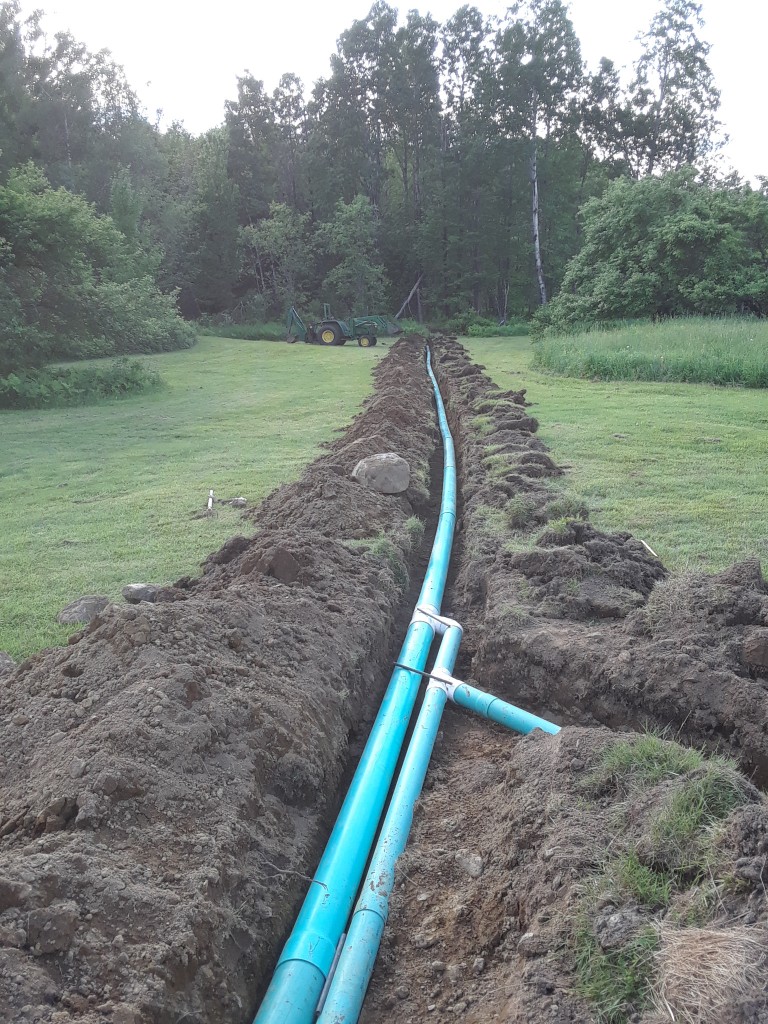 Digging the trenches and laying the pipe was the easy part.  Filling them back in and making it look like there's nothing there was hard. 