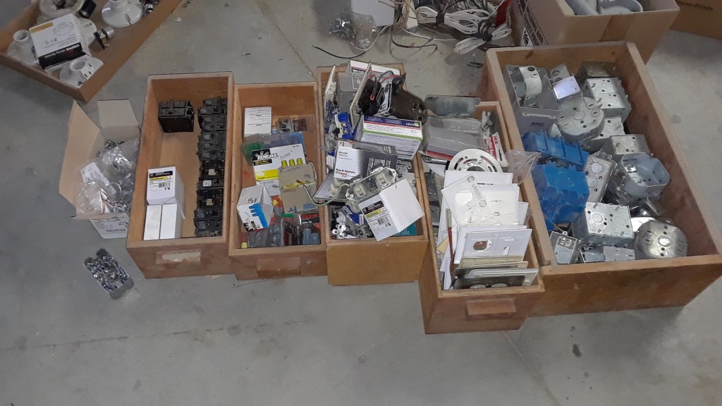 Loose screws, clamps, breakers, wire nuts, components, face plates, and boxes. Neat and tidy.